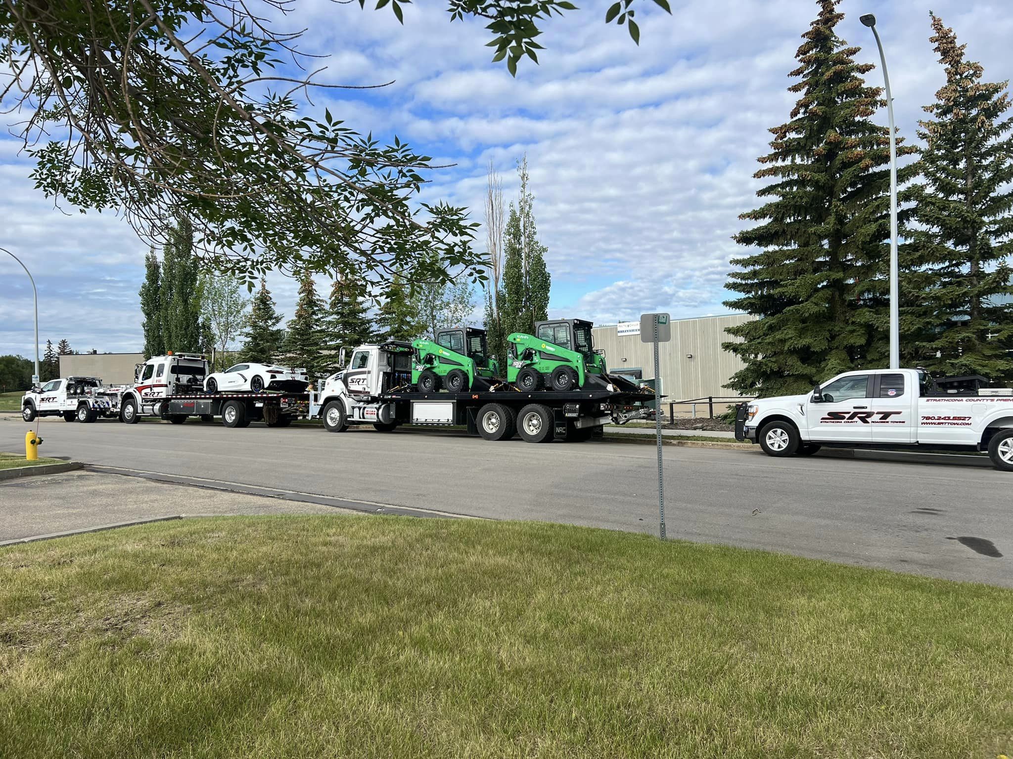 A Truck With a Couple of Tractors on the Back