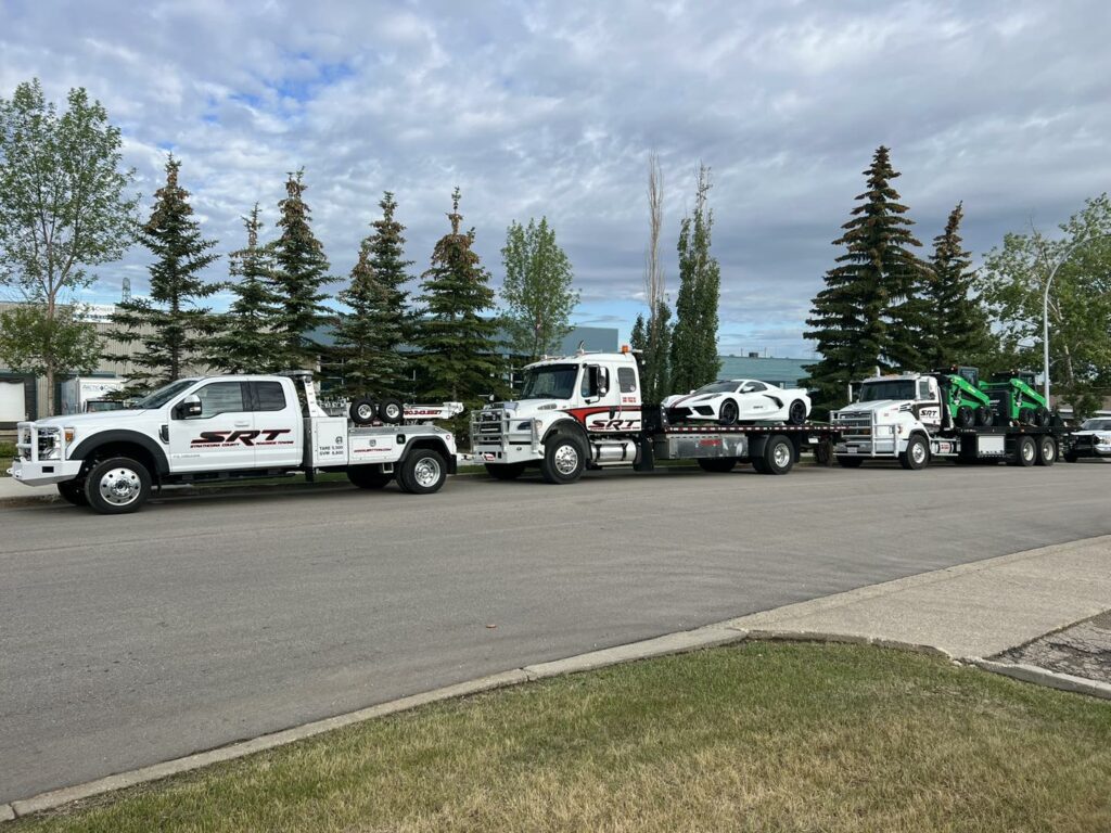 Convoy of Truck Carrying Tractors and Cars