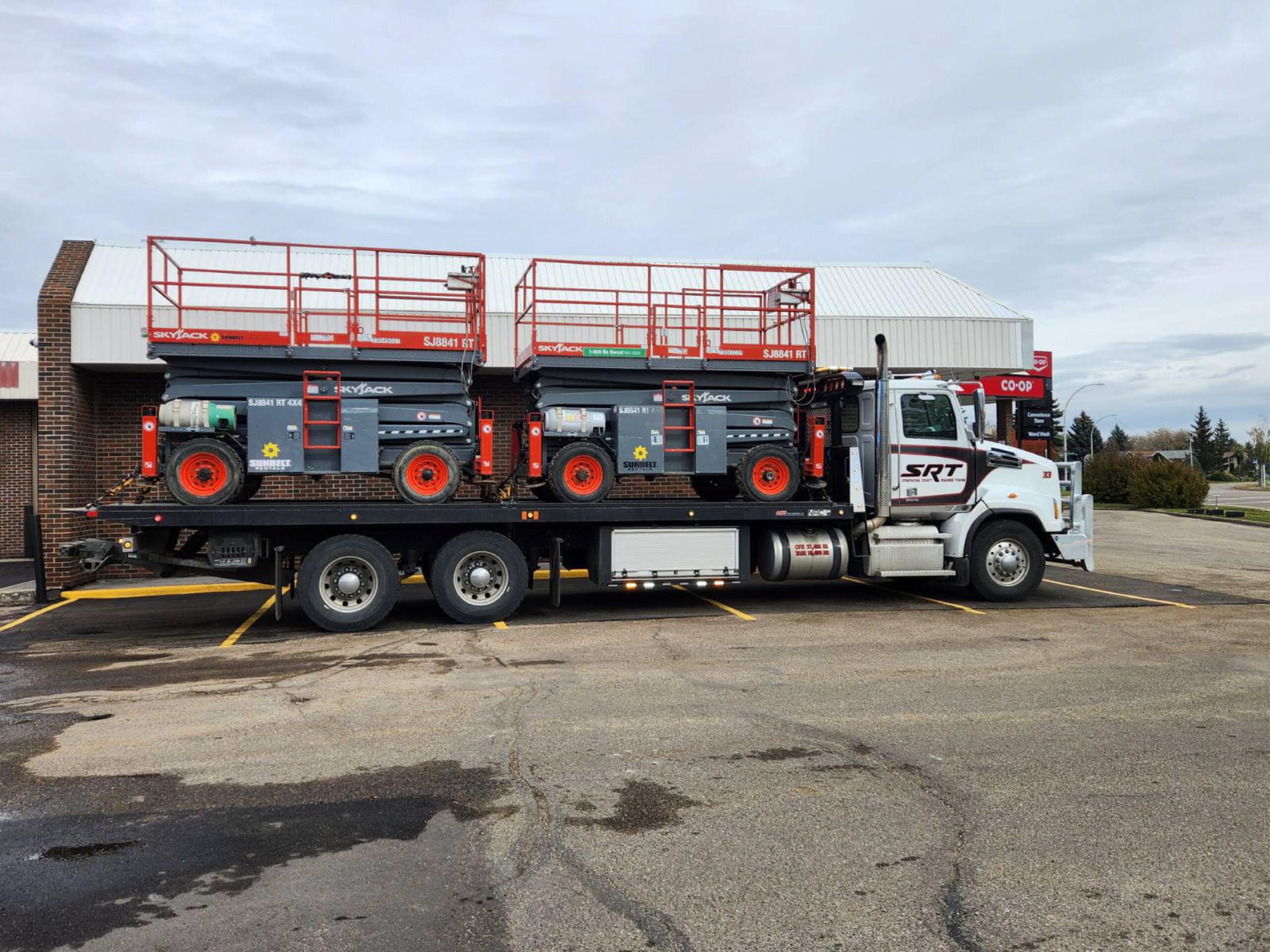 Truck Carrying Two Scissor Lifts